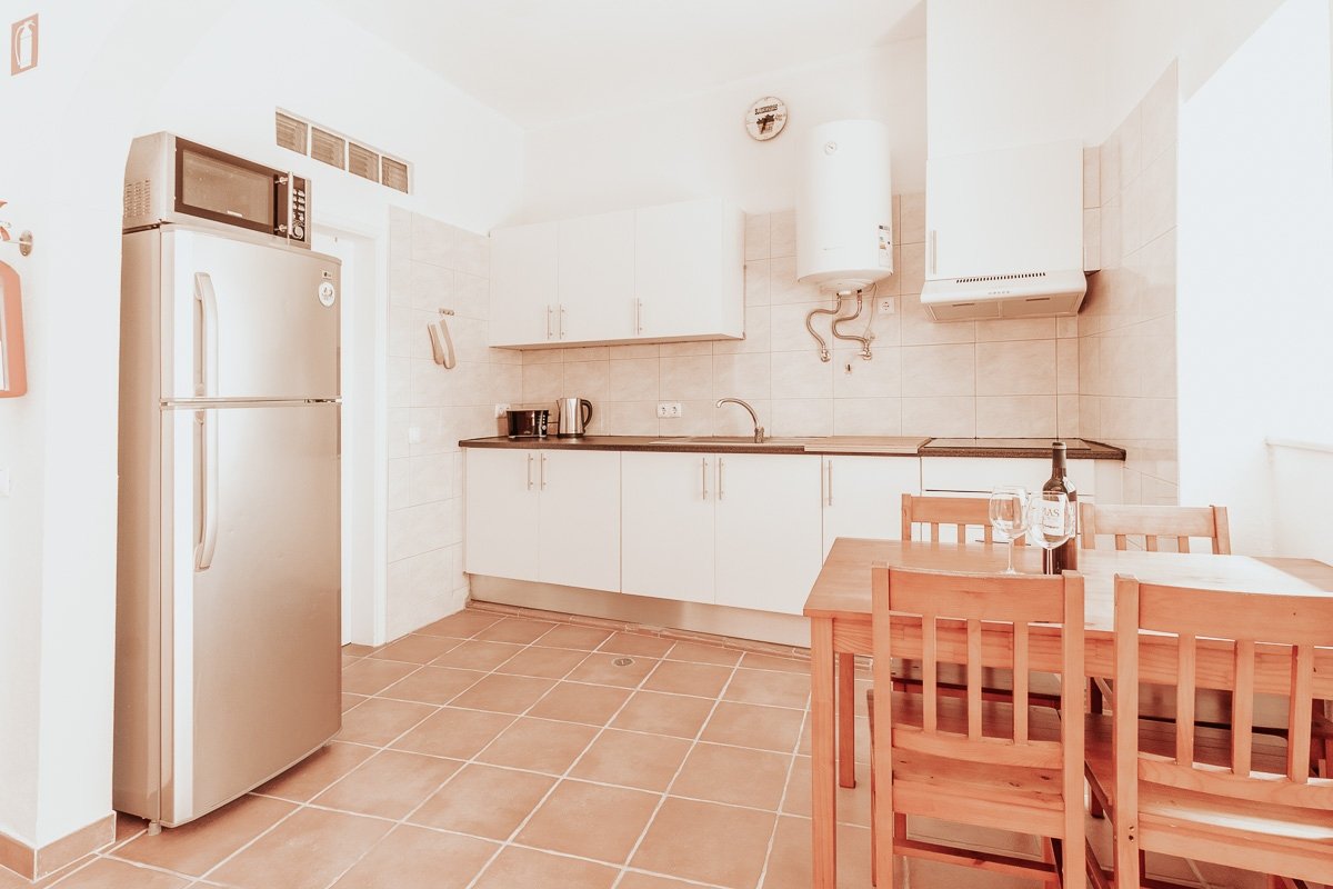 The open-plan living and kitchen area, light flooding from the side window